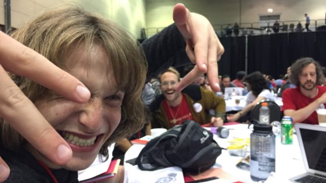 three organizers sitting at a table and smiling at the DSA convention