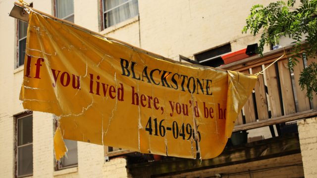 a tattered yellow Blackstone banner that reads "BLACKSTONE - If you lived here, you'd be home" 416-0496