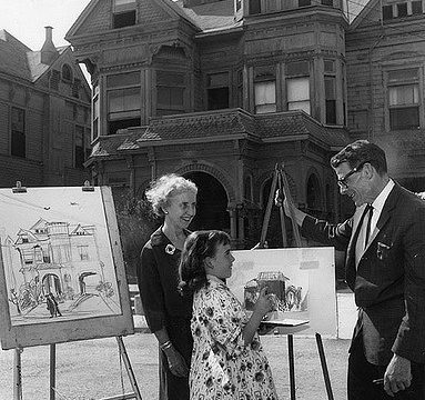 a black and white photo of Leo Politi showing building designs to a mother and daughter in Bunker Hill, Los Angeles