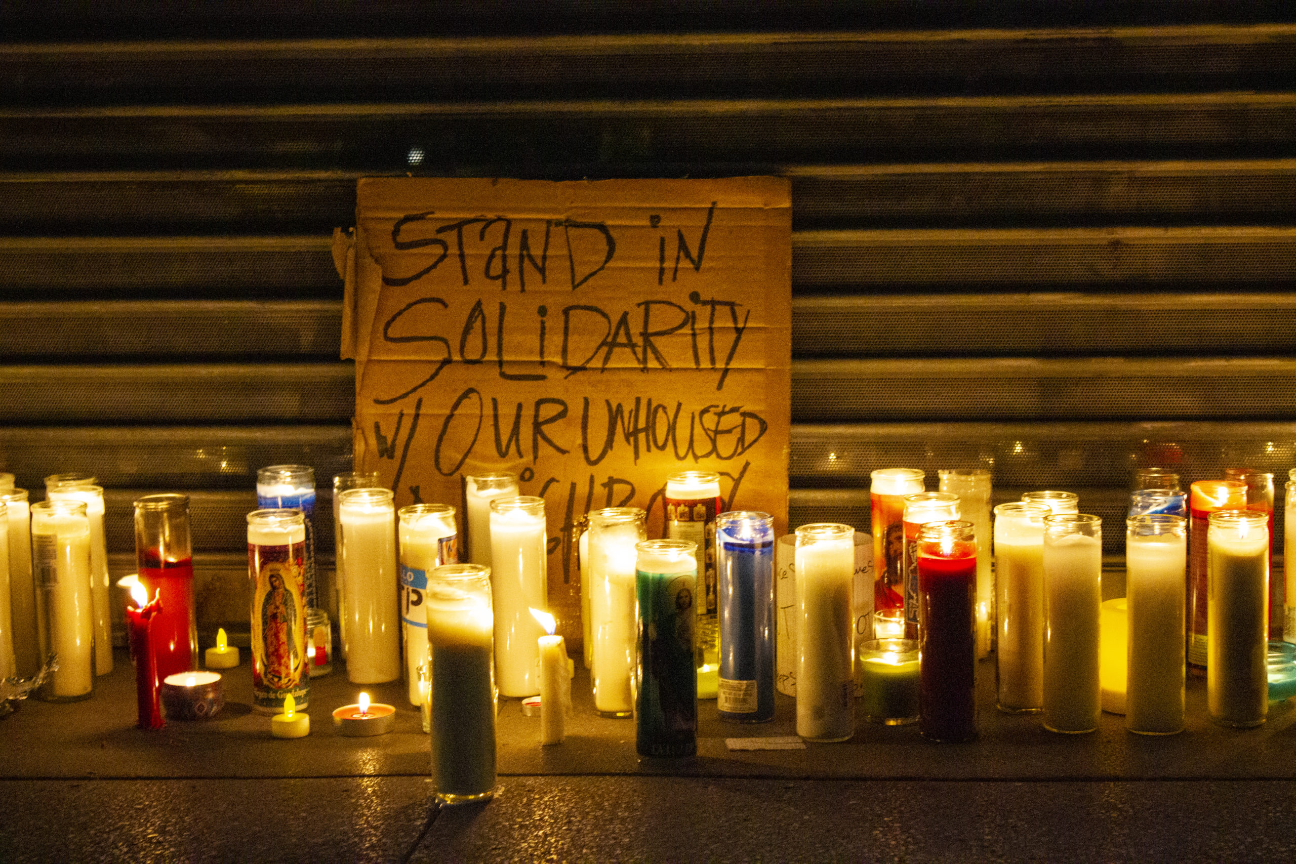 SIGN: Stand in solidarity with your unhoused neighbors, candles.