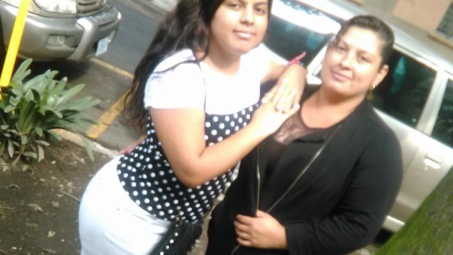 a photograph of Sandra and Brenda Guzman-Guiterrez standing on the sidewalk