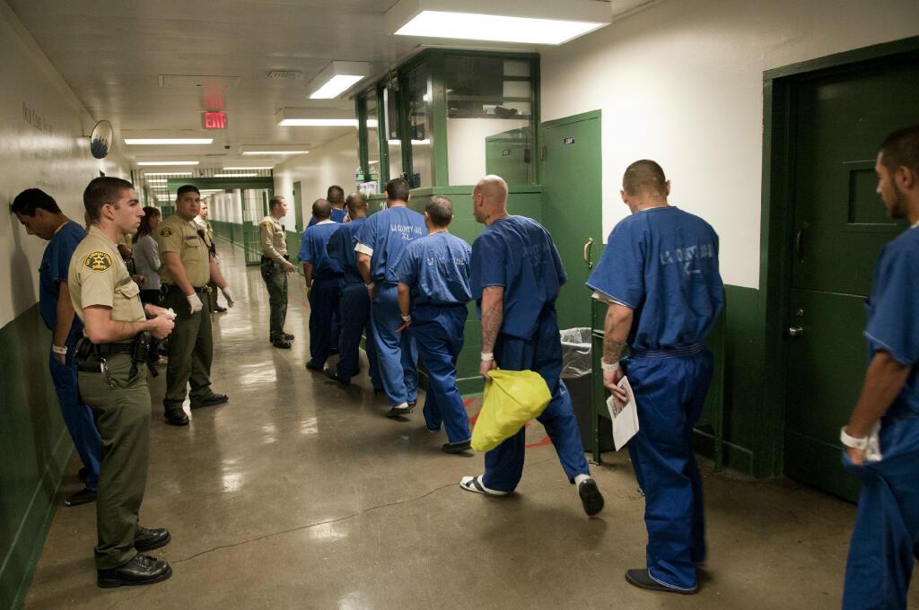 inmates walking down jail hallway