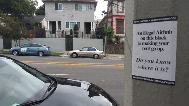 a flyer posted on a street poll reads "An illegal Airbnb on this block is making your rent go up. Do you know where it is?"