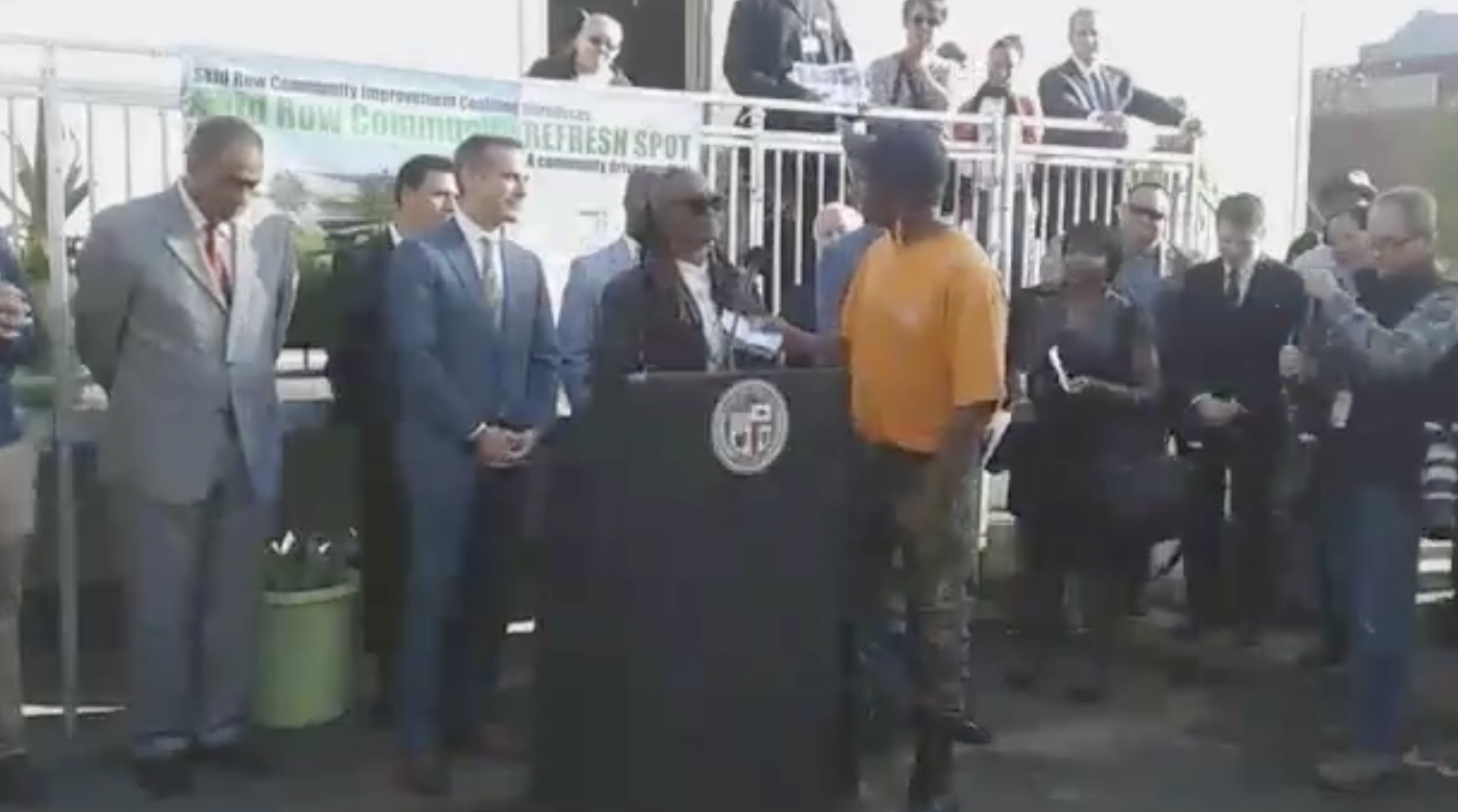 Garcetti holds a press conference in Skid Row to announce the opening of six bathrooms on Skid Row. Garcetti presented awards to community organizers who were strong advocates for the bathrooms including General Dogon of LA CAN who tears up the award in front of Garcetti.