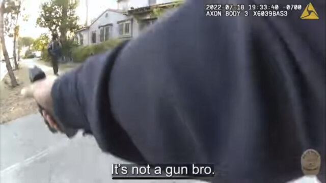 Bodyworn camera shows a police officer with his arm extended holding a gun. it is captioned with the officer saying "It's not a gun bro."