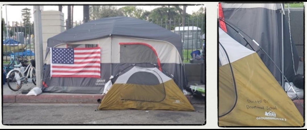 This is a picture of Veterans Row - a small pup tent donated by Brentwood School is in front of a larger tent with an American flag