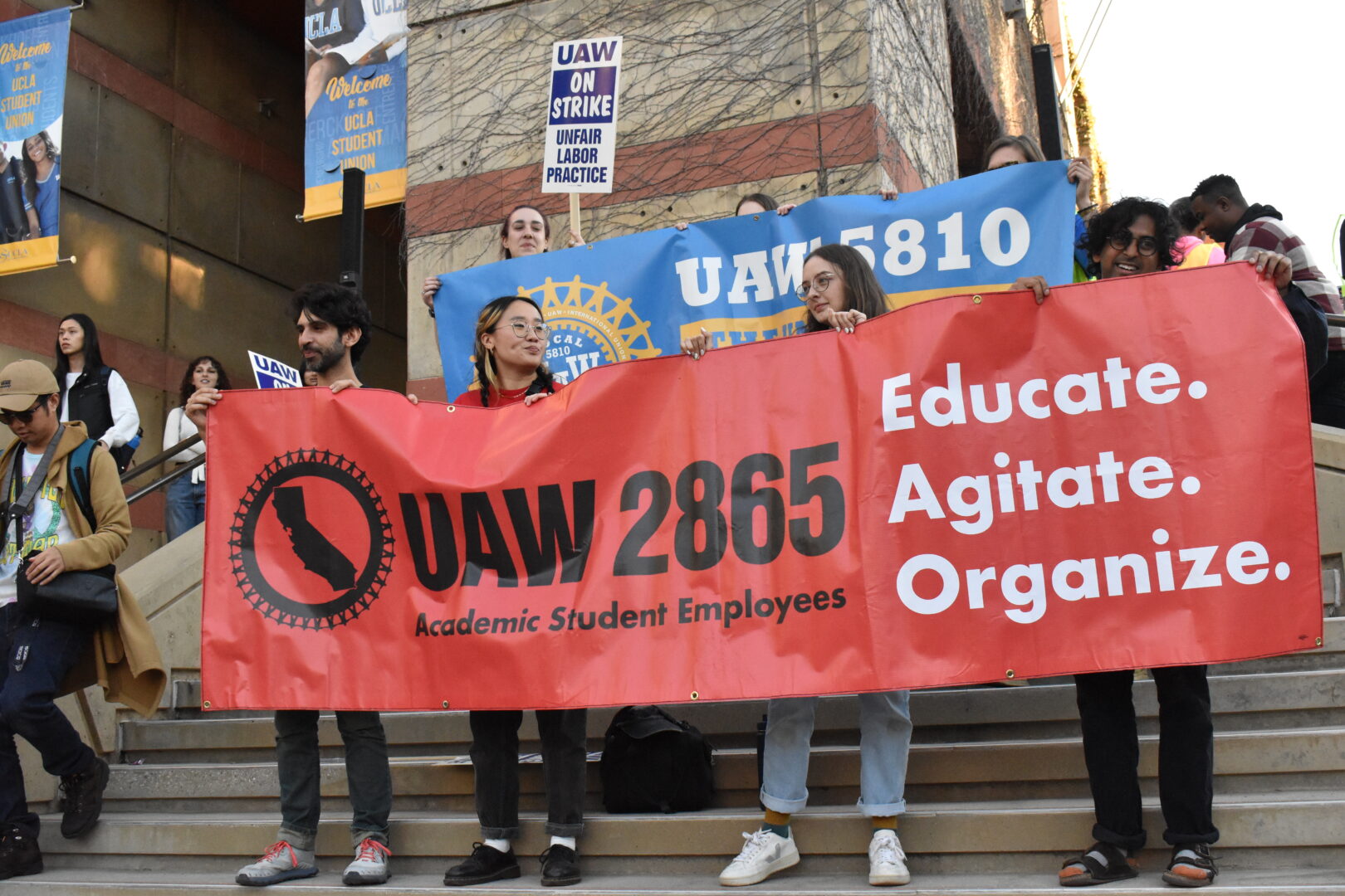 Strikers holding UAW 2865 banner